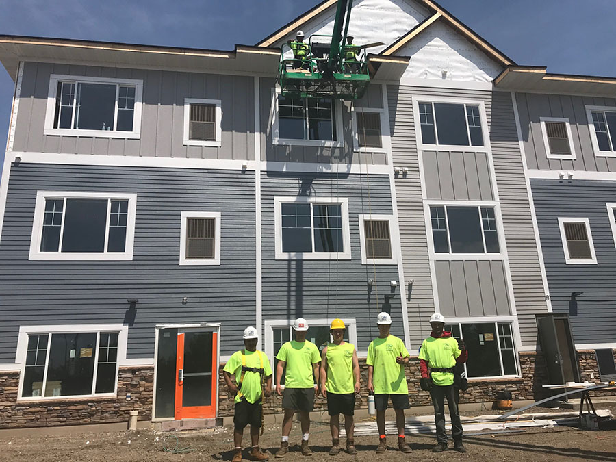 Crew in front of a siding job