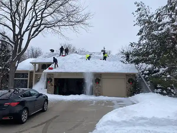 Crew removing snow from roof
